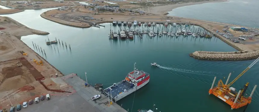 Boats in harbour and construction cranes from bird's-eye view
