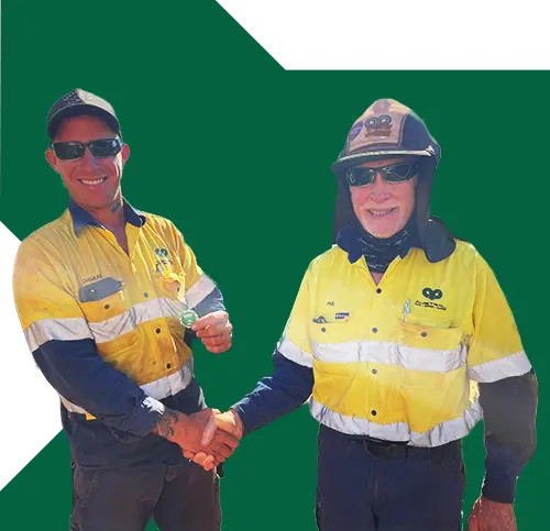 2 male contractors smiling at the camera while shaking each other's hand