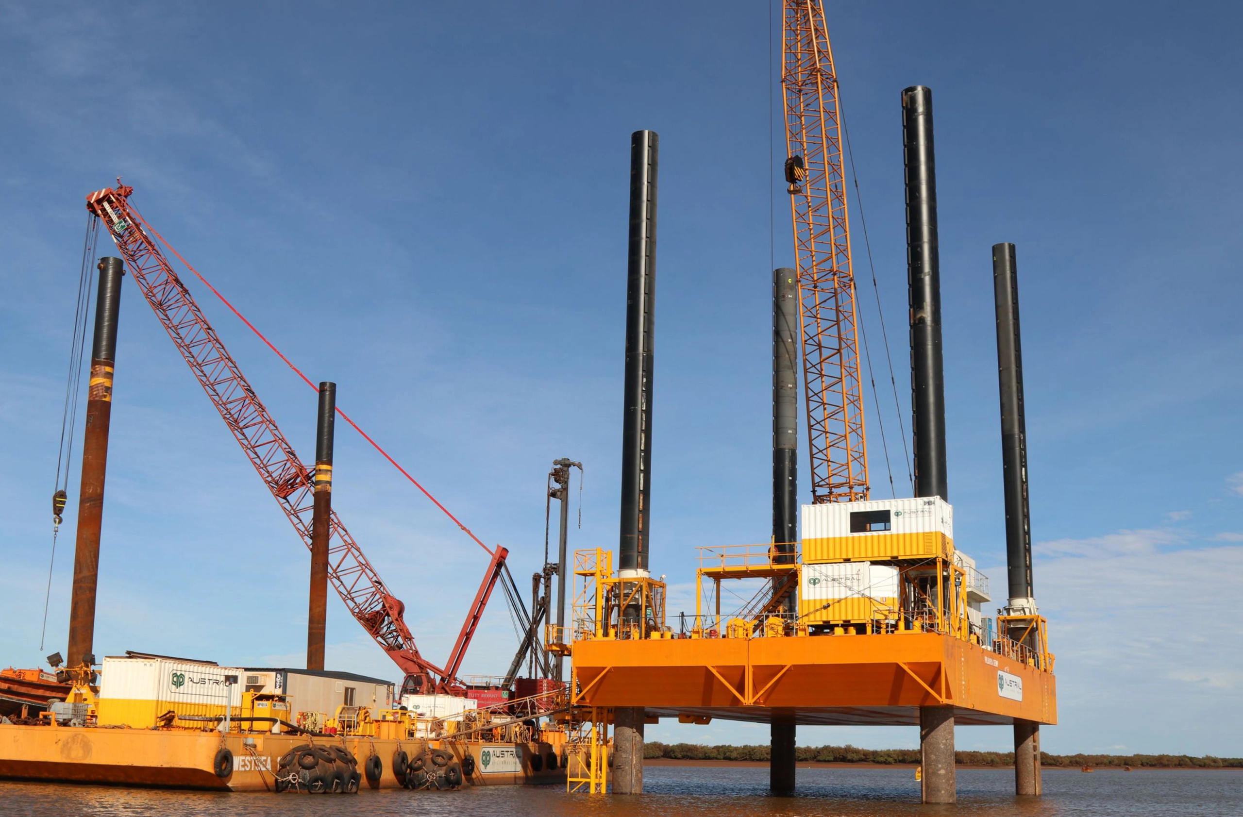 A big yellow crane and construction equipment